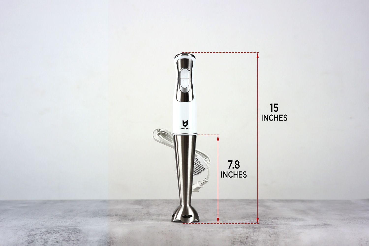 The UTALENT Hand Blender stands on top of its blending shaft on a gray table, with the length of the blending shaft being noted to the side as 7.8 inches, and the total length of the unit as 15 inches.