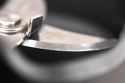 A close-up of the sharp stainless steel blade of the Vitamix immersion blender. 