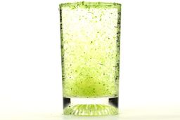 A glass of water combined with fibrous greens pulp produced by the Nutribullet Pro Single-Serve Blender.