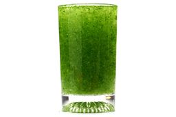 A glass of water combined with fibrous greens pulp produced by the Magic Bullet Single-Serve Blender.