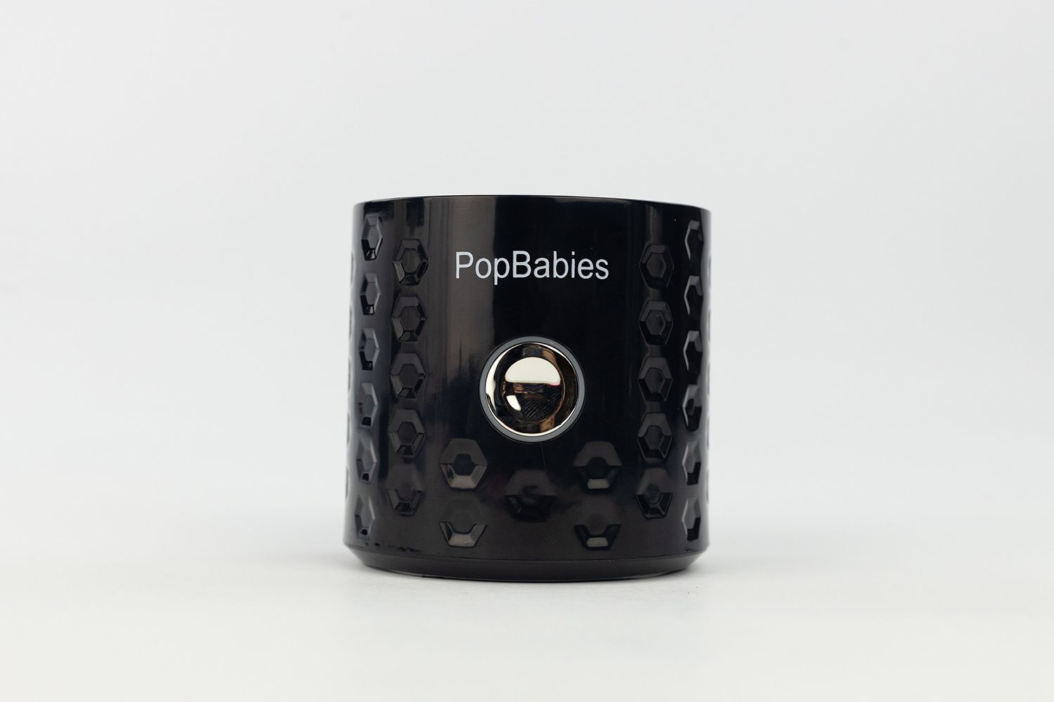 A close-up of the power button on the motor base of the PopBabies