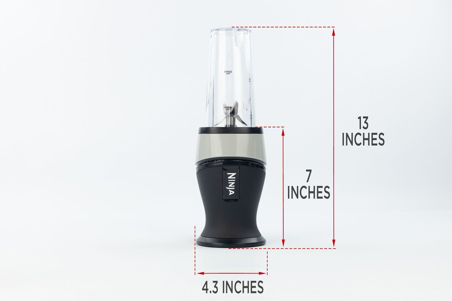 The Ninja Fit Personal Blender standing on a gray table, with the length of its motor base being noted to the side as 7 inches, and the total length and width of the unit as 13 inches and 4.3 inches, respectively.