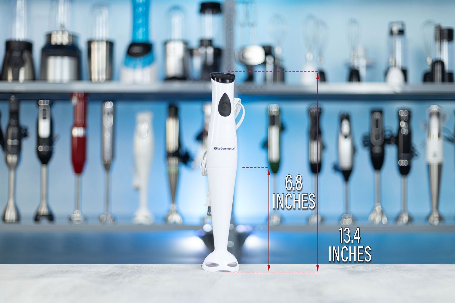 The Elite Gourmet EHB-2425X hand-held blender standing on top of its blending shaft on a table, with the length of the shaft being noted to the side as 6.8 inches, and the total length of the unit as 13.4 inches.