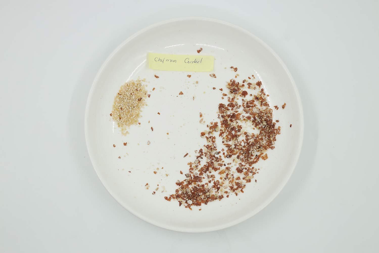 Plate labeled Chefman-corded containing almond particles