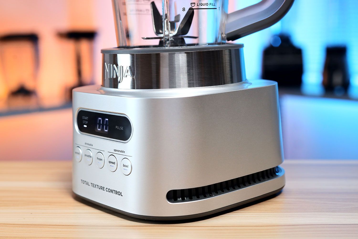 Angled close-up of the Ninja TWISTi blender base, highlighting the control interface and airflow vents.