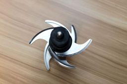 Close-up of the BL610 blade assembly showing curved stainless steel blades.