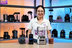 To test the Ninja SS151 TWISTi Blender Duo, Tina makes almond butter. She times the blend on her phone and assesses smoothness by taking a spoonful, spreading it thin on a sheet, and showing how creamy it is.