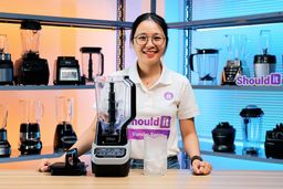 Tina tests the Ninja BL610 full-size blender by crushing ice. Once the cycle finishes, she pours the crushed ice into a black tray so the texture is easier to see and evaluate.