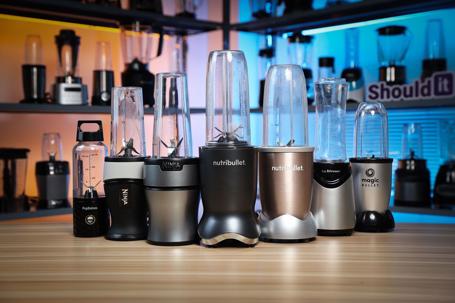 Lineup of personal blenders including Ninja, Nutribullet, and Magic Bullet displayed on a countertop at Shouldit Lab for comparison testing.
