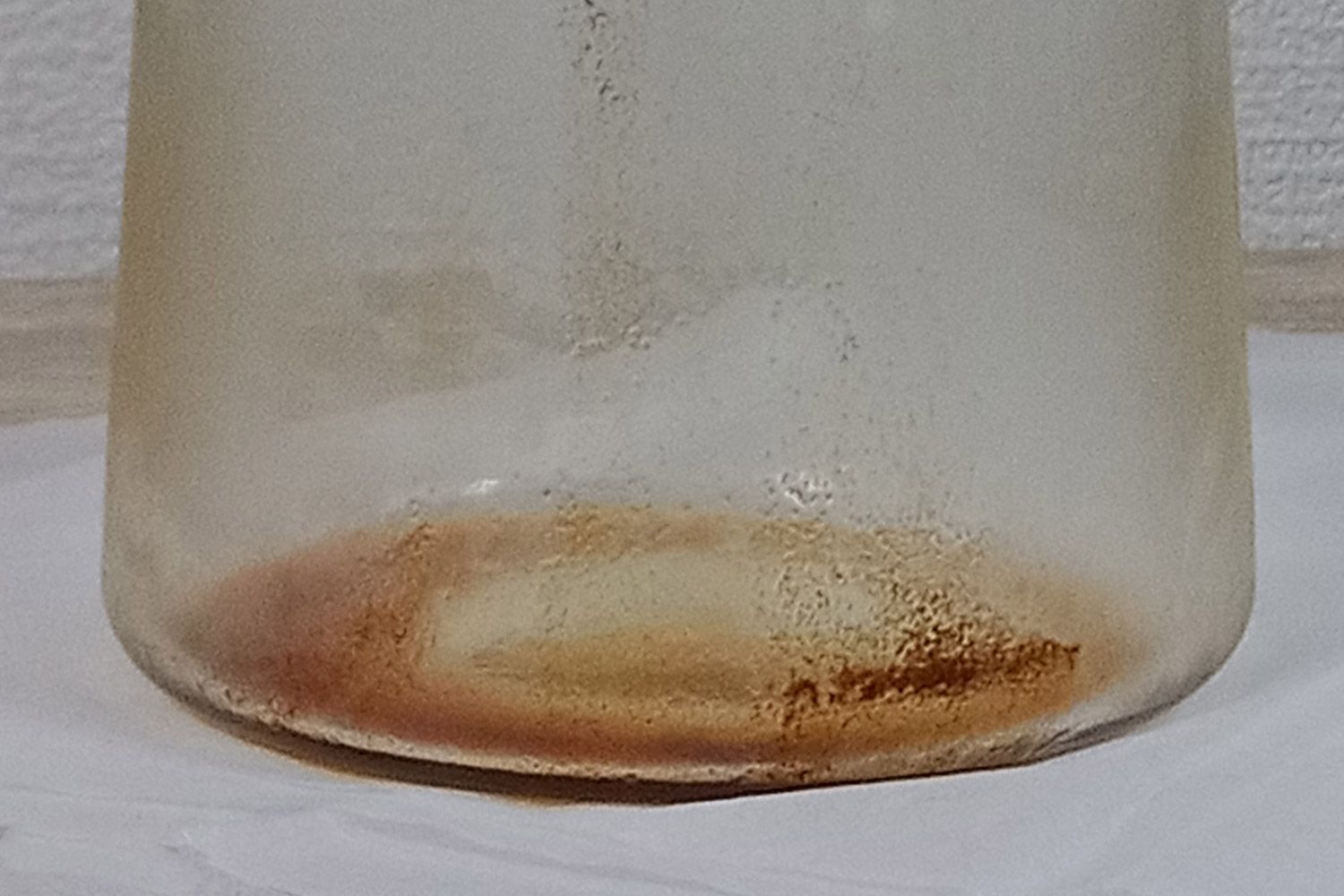 Sediment at the bottom of the Oxo compact cold brew coffee carafe after all the coffee has been carefully decanted out.