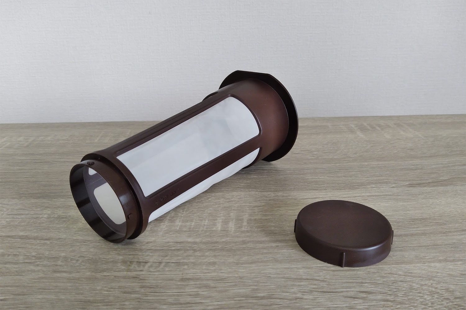 A small plastic and nylon cold brew coffee filter with a detachable base for easy cleaning.