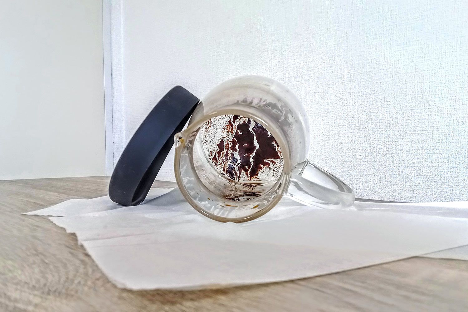 The inside of a cold brew coffee carafe showing leftover sediment.