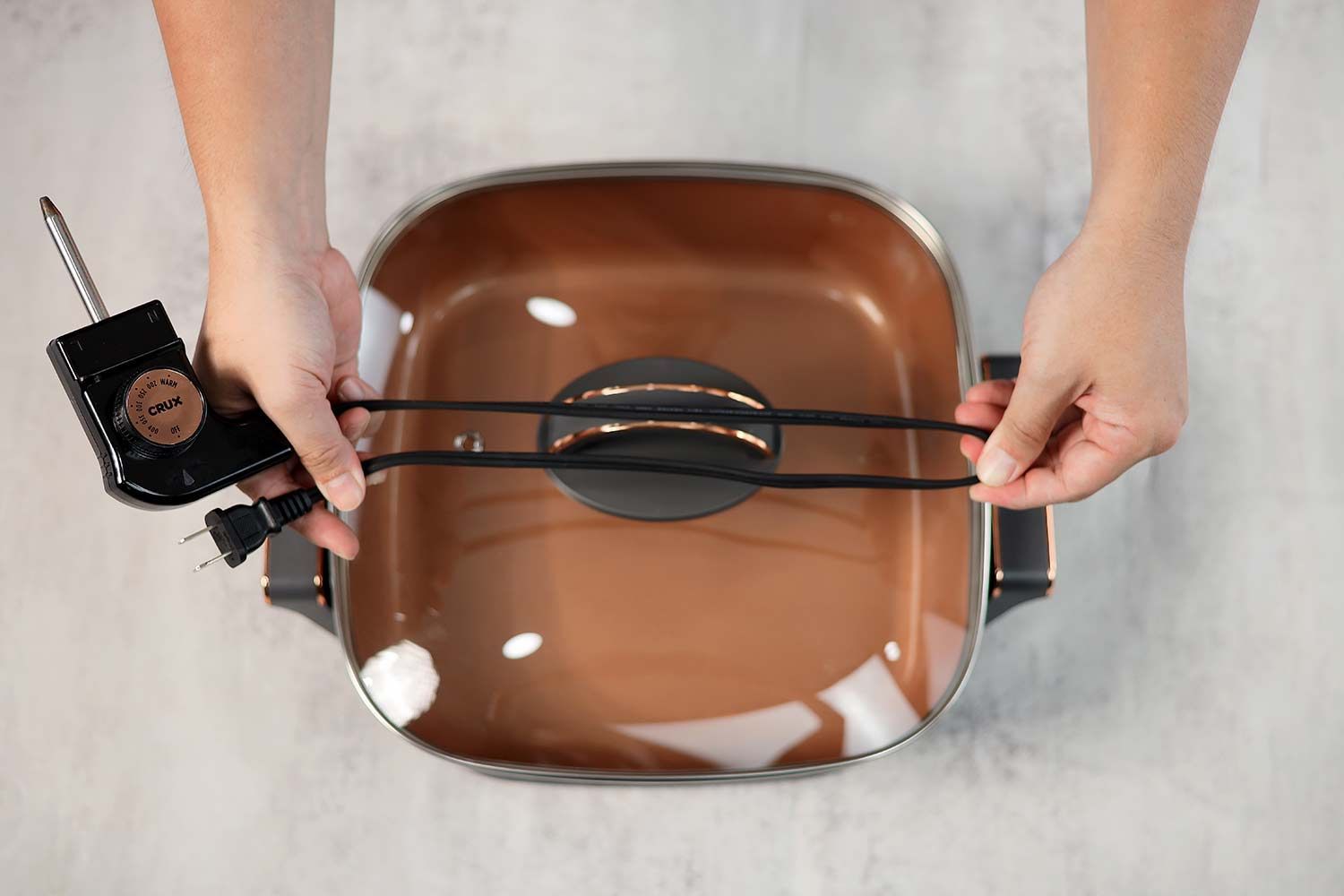 The flat two-prong power cord of the Crux Non-Stick Electric Skillet 14620 is 31.1 inches long.