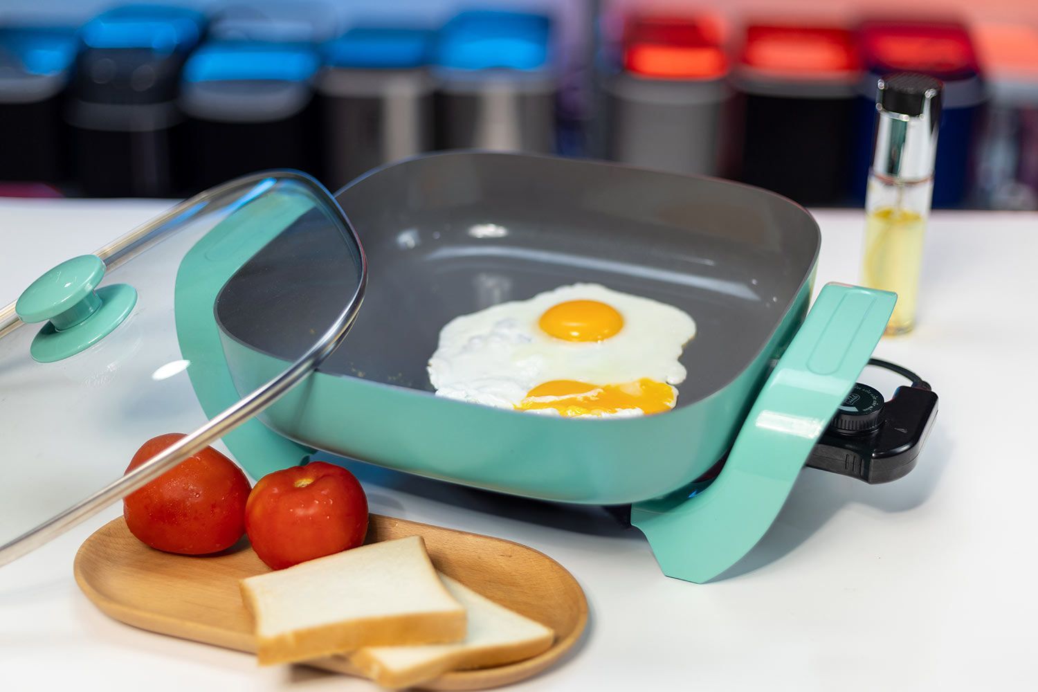 Breakfast made with the GreenLife Ceramic Non-Stick Electric Skillet CC003725-002. Two fried eggs, two slices of bread, and two fresh tomatoes.