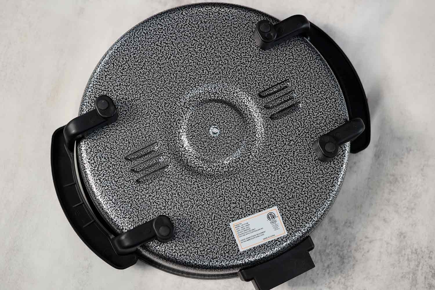 The base of the Ovente Non-Stick Electric Skillet SK11112B has four stands with anti-slip pads.