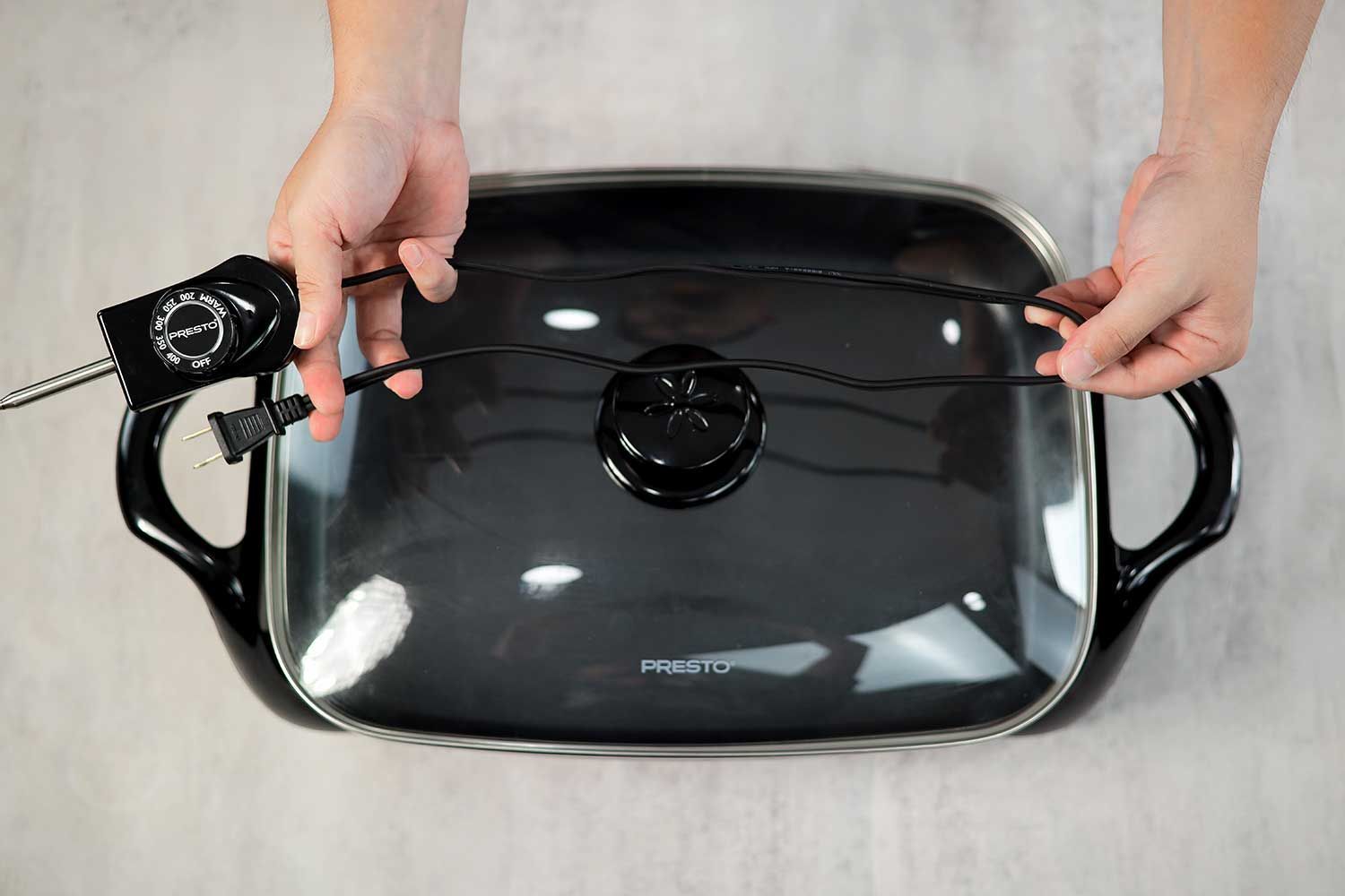 The flat two-prong power cord of the Presto Electric Skillet 06852 is 31.1 inches long.