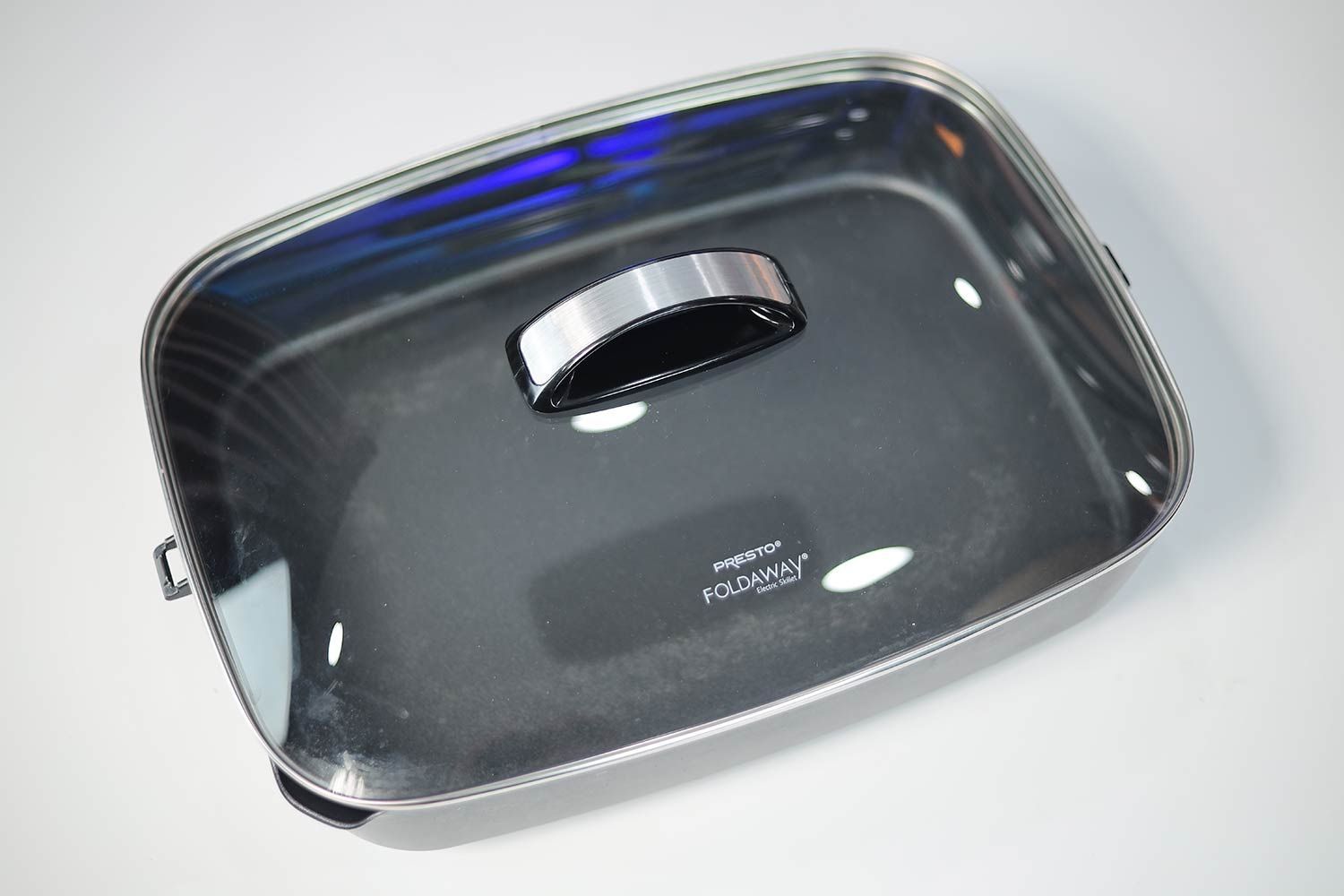 The tempered glass lid of the Presto Foldaway Non-Stick Electric Skillet 06857.