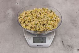 14.24 ounces of assorted ground scraps, including dietary fibers, bones, etc., on digital scale, on granite-looking top.