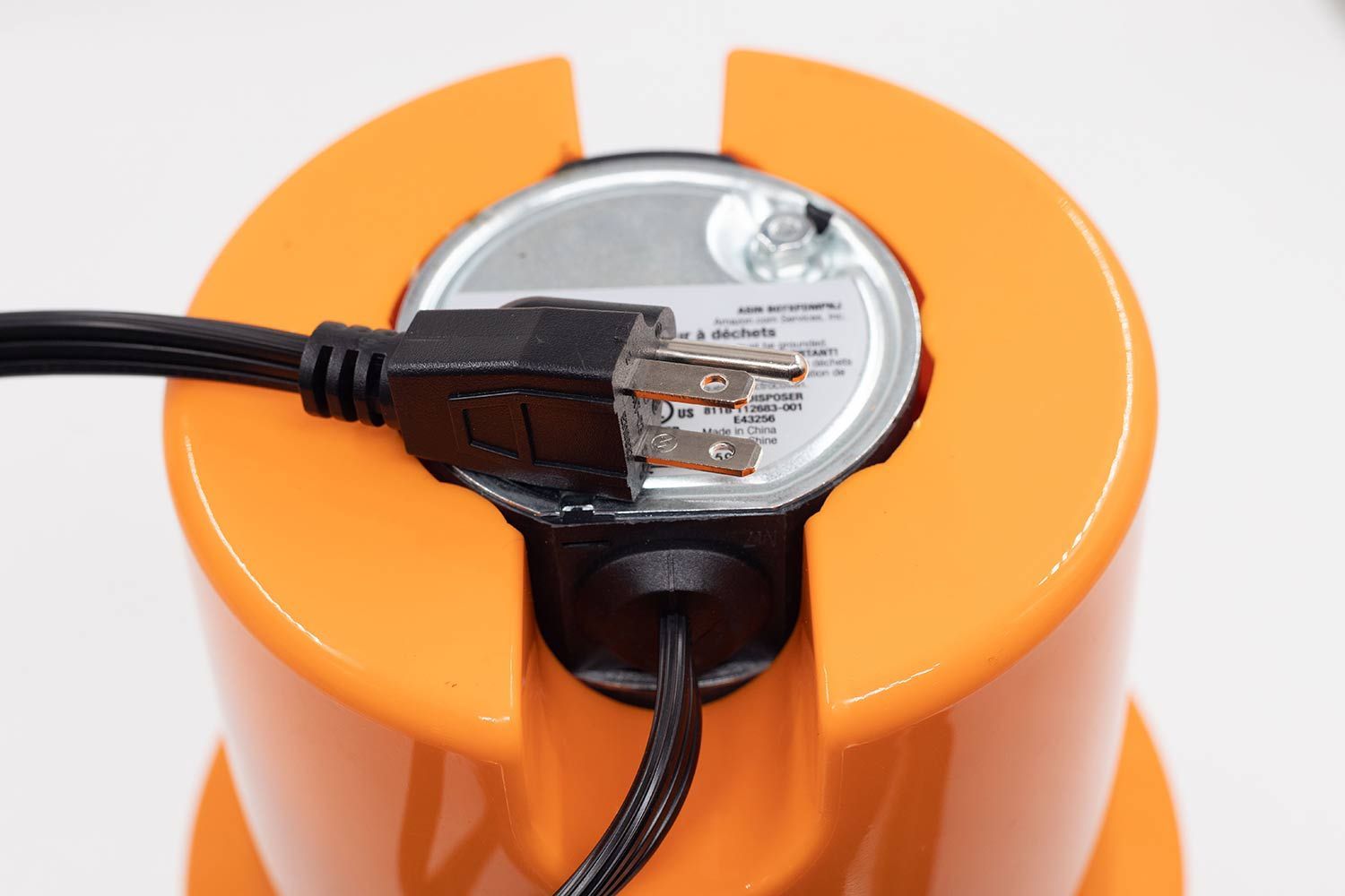 Bottom view of AmazonCommercial 3/4 HP corded garbage disposal with type-B power cord.