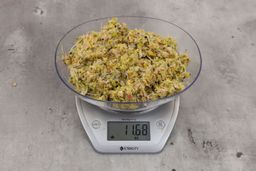 11.68 ounces of assorted scraps from garbage disposal on digital scale on granite-looking top.