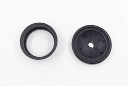 Parts of Universal 3-Bolt Mount Adapter for garbage disposals on white top, collar adapter and rubber sink baffle.