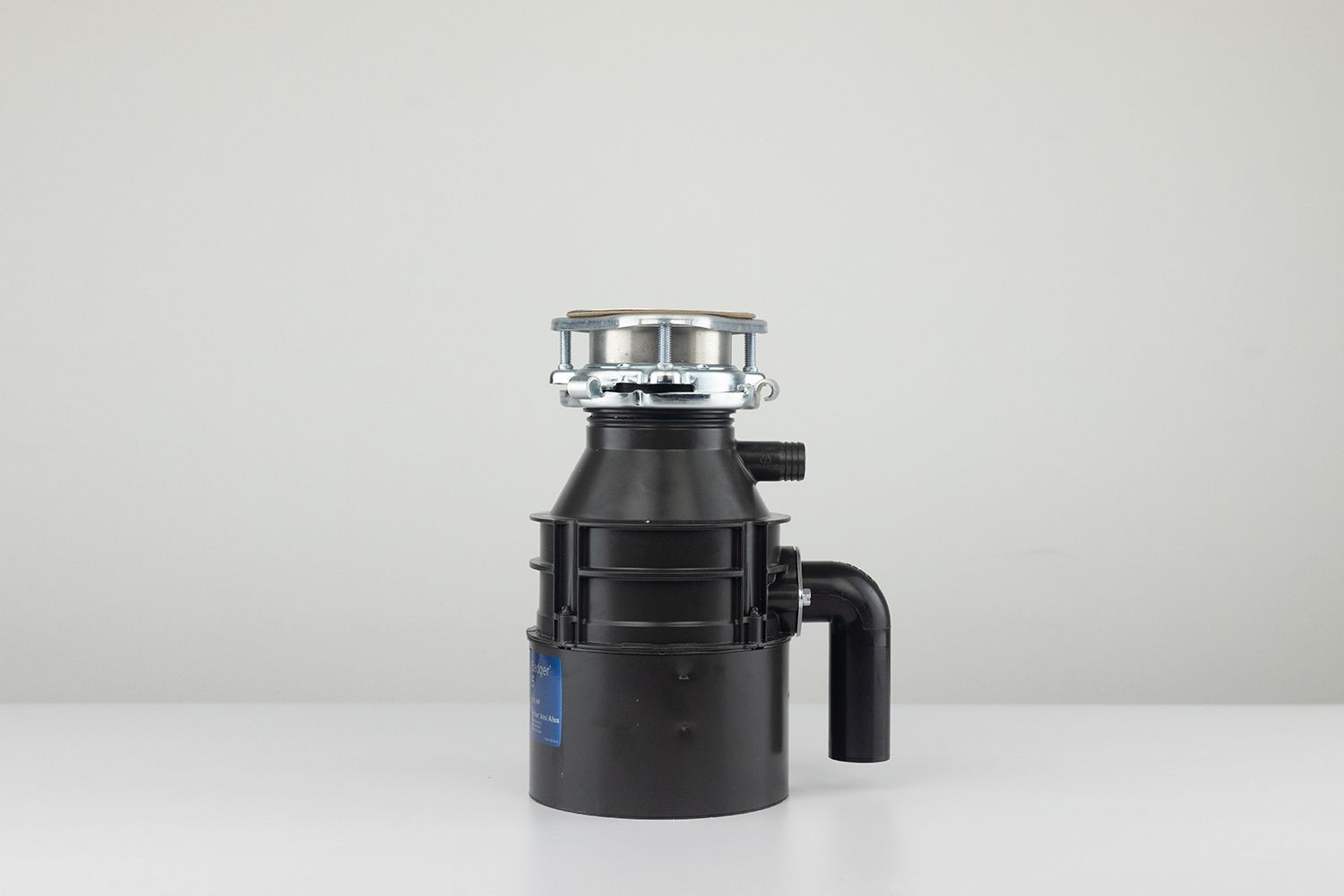 InSinkErator Badger 5 1/2 HP Garbage Disposal, with 3-Bolt Mount assembly on top and outlet/discharge set in place.