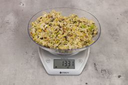 13.31 ounces of fish pin bones in mess of assorted scraps from garbage disposal on digital scale on granite-looking top.