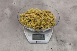 11.03 ounces of fish pin bones in mess of assorted scraps from garbage disposal on digital scale on granite-looking top