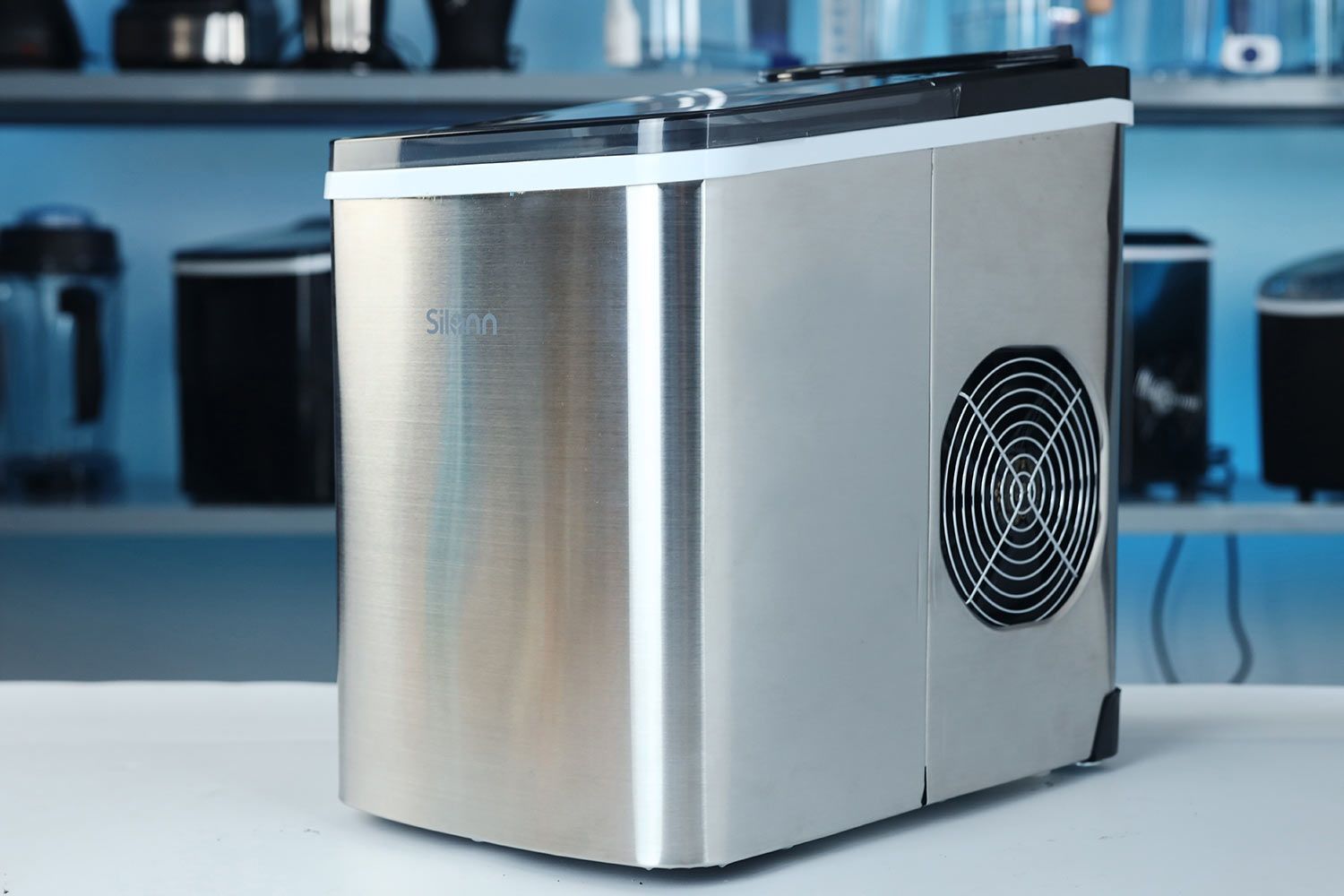 A side view of the Silonn portable ice maker showing the stainless steel body and the extraction fan on the right hand side