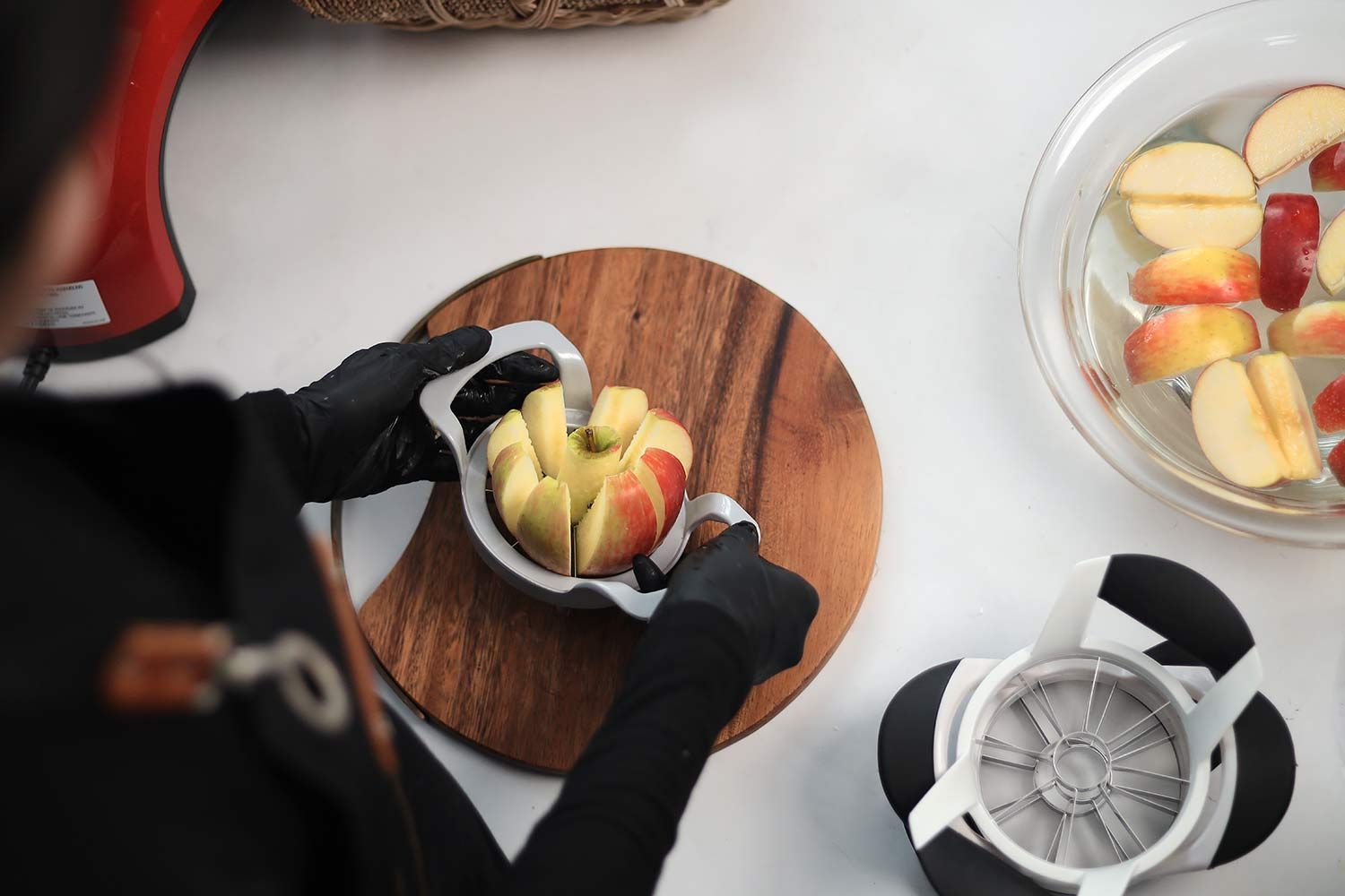 Person cutting an apple using an apple corer slicer