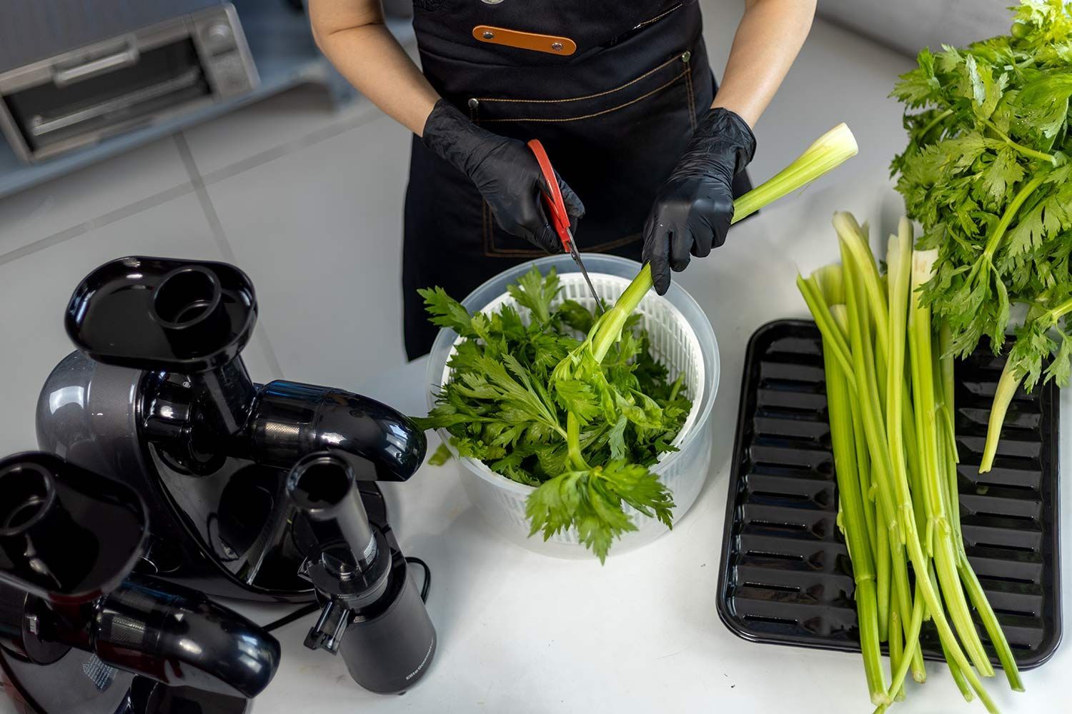 Person cutting a stalk of celery