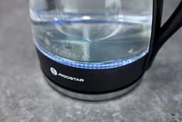 The heating plate with a LED ring around it glowing blue of the Aigostar Electric Kettle 300104LCB.