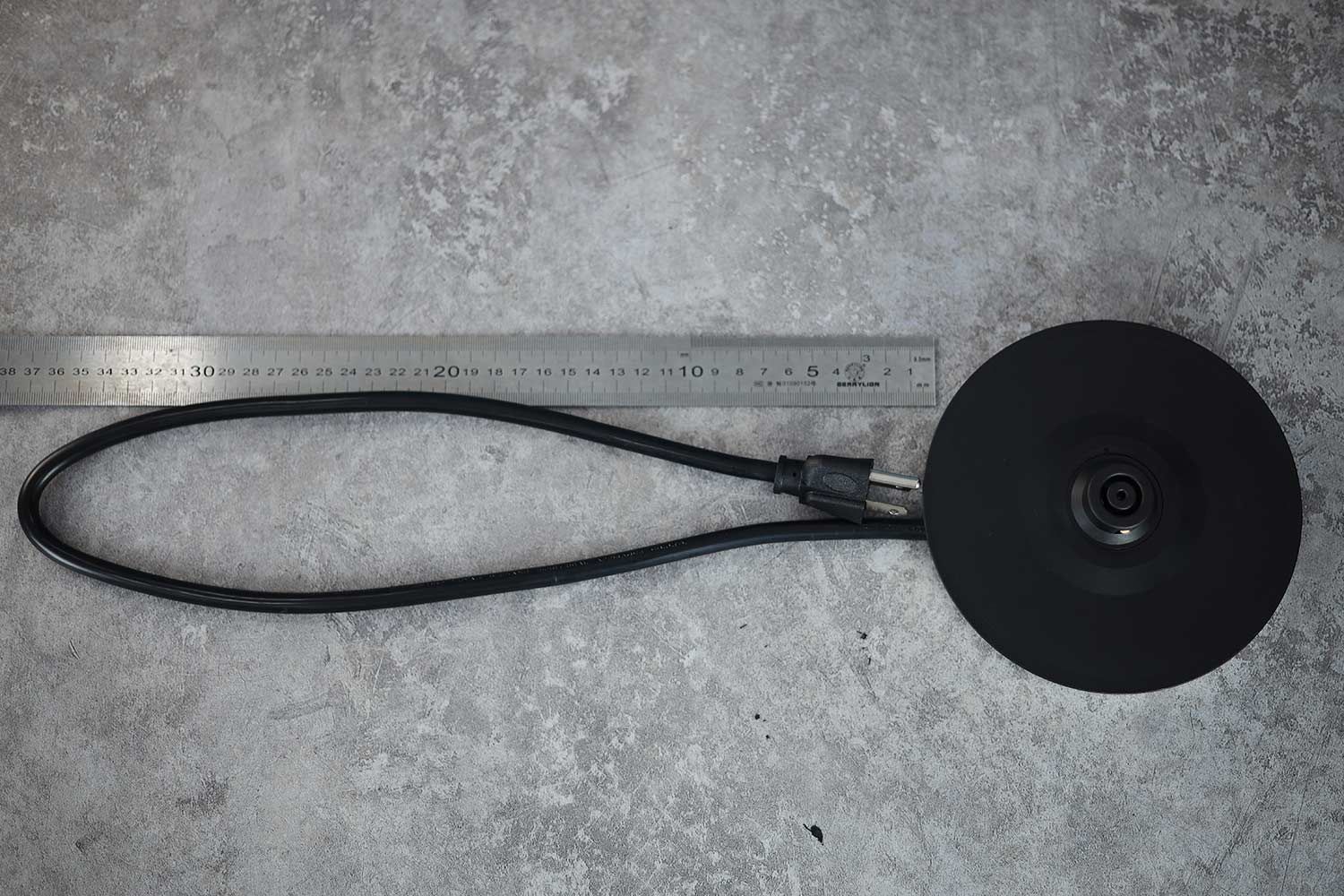 The three-pronged round power cord of the Aigostar Electric Kettle 300104LCB is 29.53 inches long (75 cm).