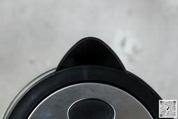 The plastic black V-shaped spout of the Amazon Basics Electric Glass and Steel Kettle (F-625C).