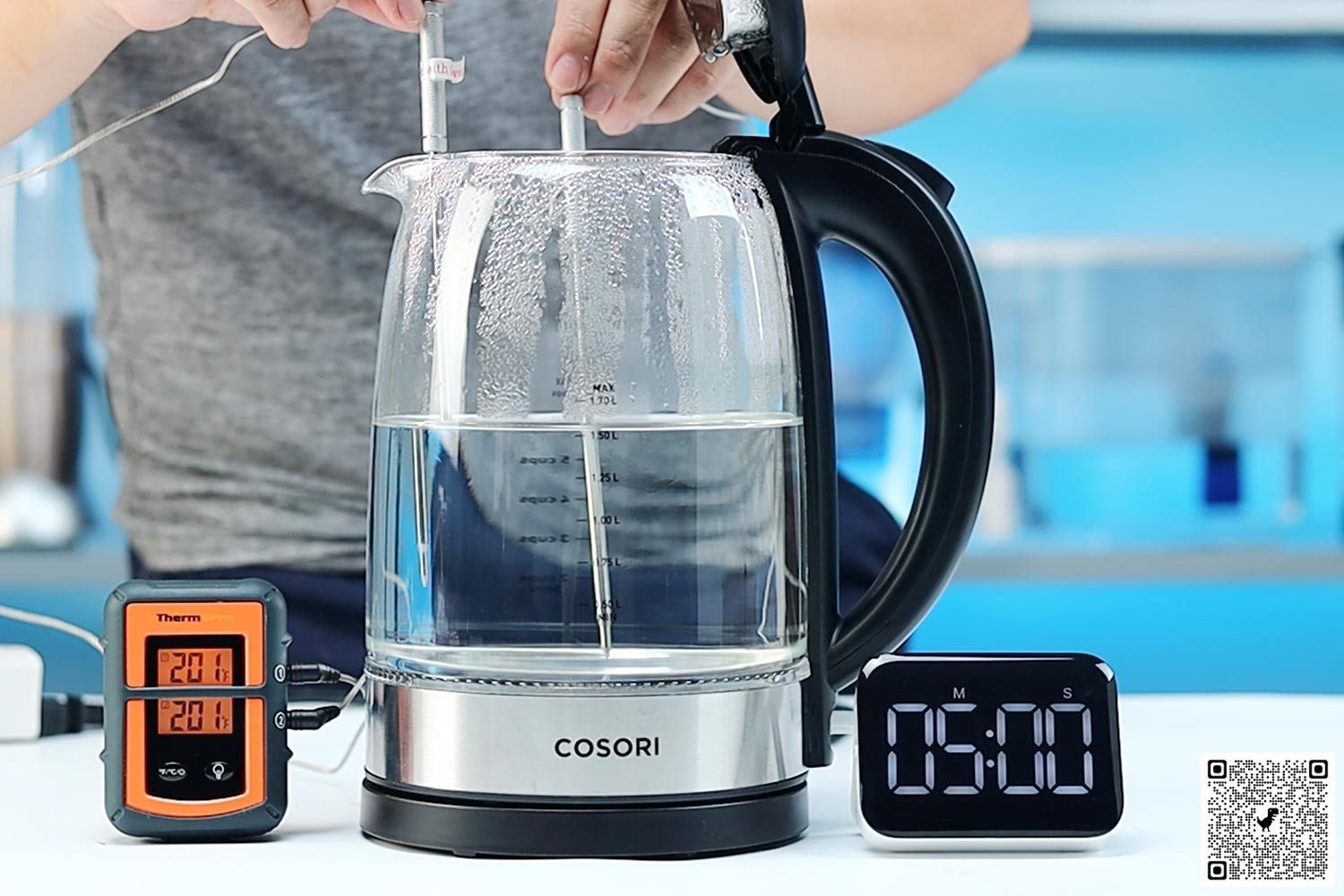 On the right is a Thermo Pro two-probe digital thermometer displaying 200°F for both probes. In the middle is the Cosori Glass Electric Kettle (GK172-CO) Keep Warm with 1.5 liters of water and two probes inside. On the right is a digital timer displaying 5 minutes on the countdown.