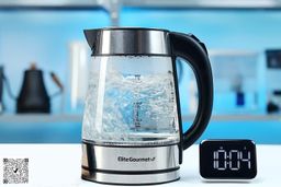 1.5 liter of water boiling inside the Elite Gourmet Electric Glass Kettle (EKT-602). The digital timer displays 10 minutes and 04 seconds.