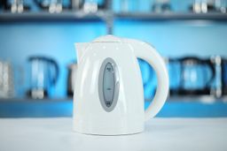 The carafe of the Ovente Electric Kettle KP72W sitting on top of its power base.