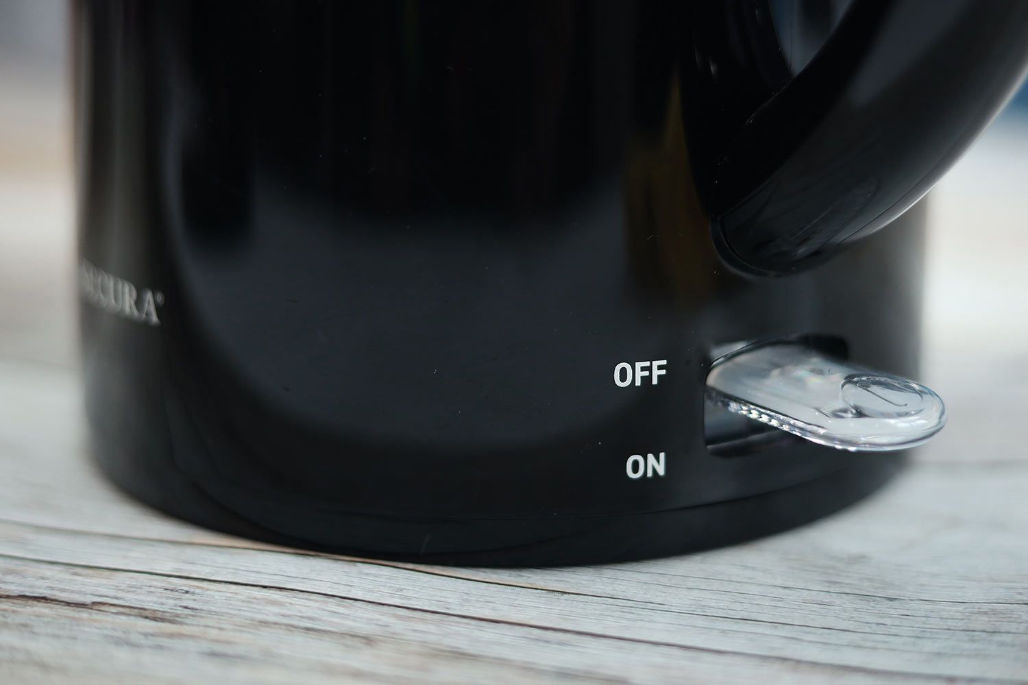 The clear plastic power switch of the Secura Electric Stainless Steel Double-Wall Kettle (SWK-1701DA).