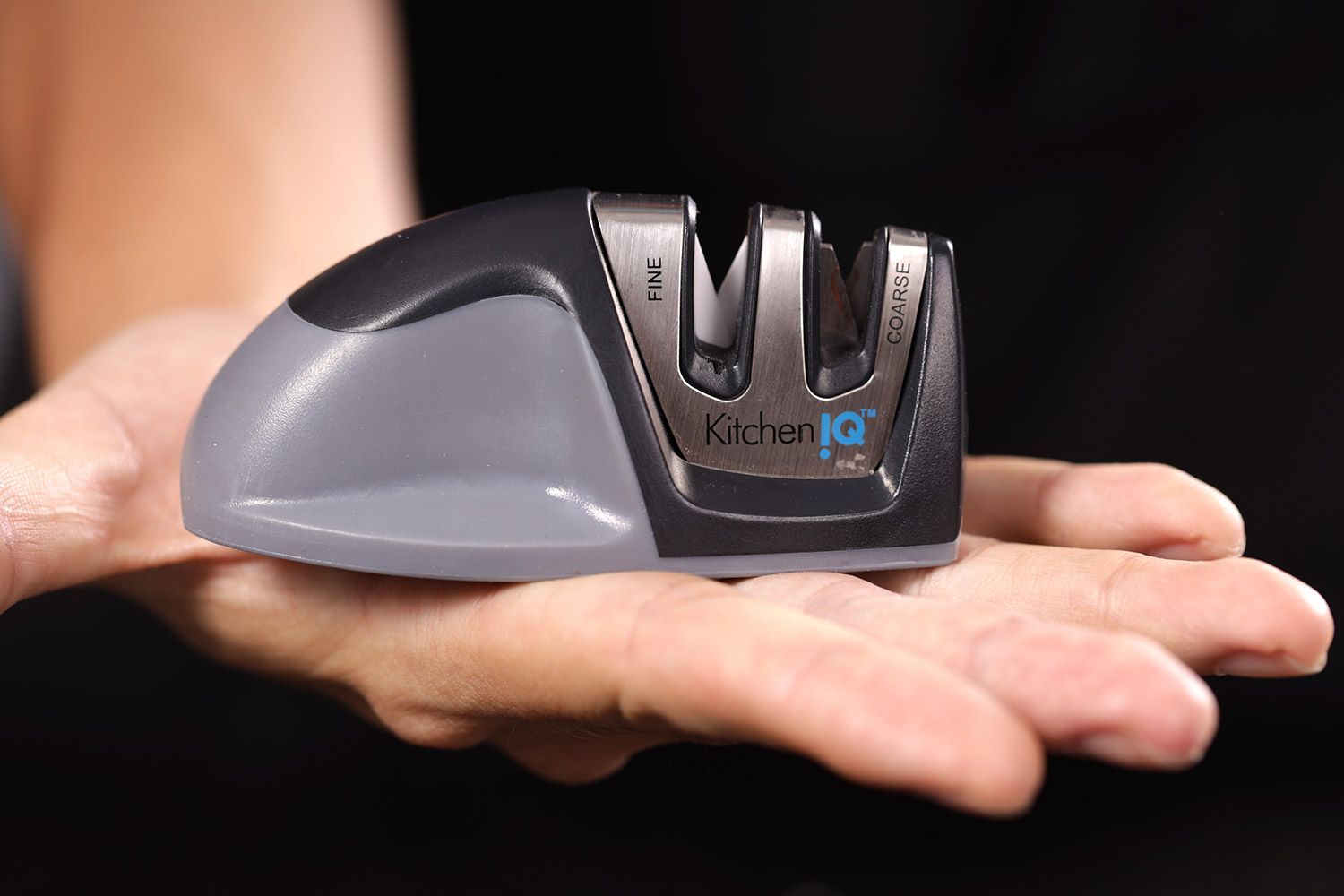 The KitchenIQ Edge Grip knife sharpener in an open hand