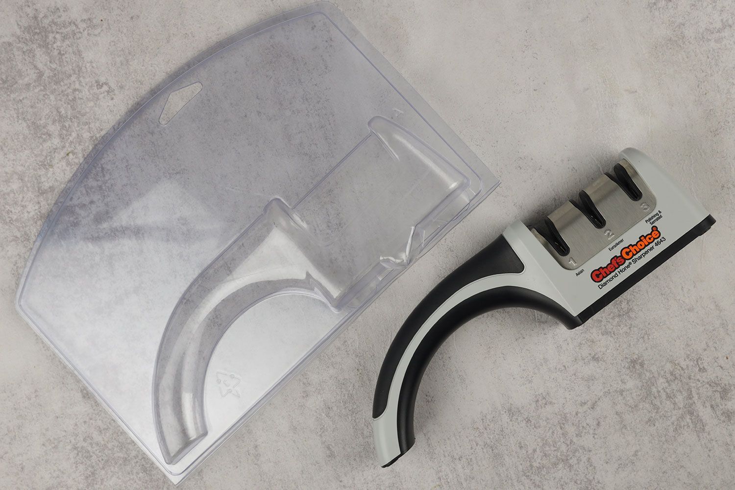 The Chef’s Choice manual knife sharpener next to its plastic case