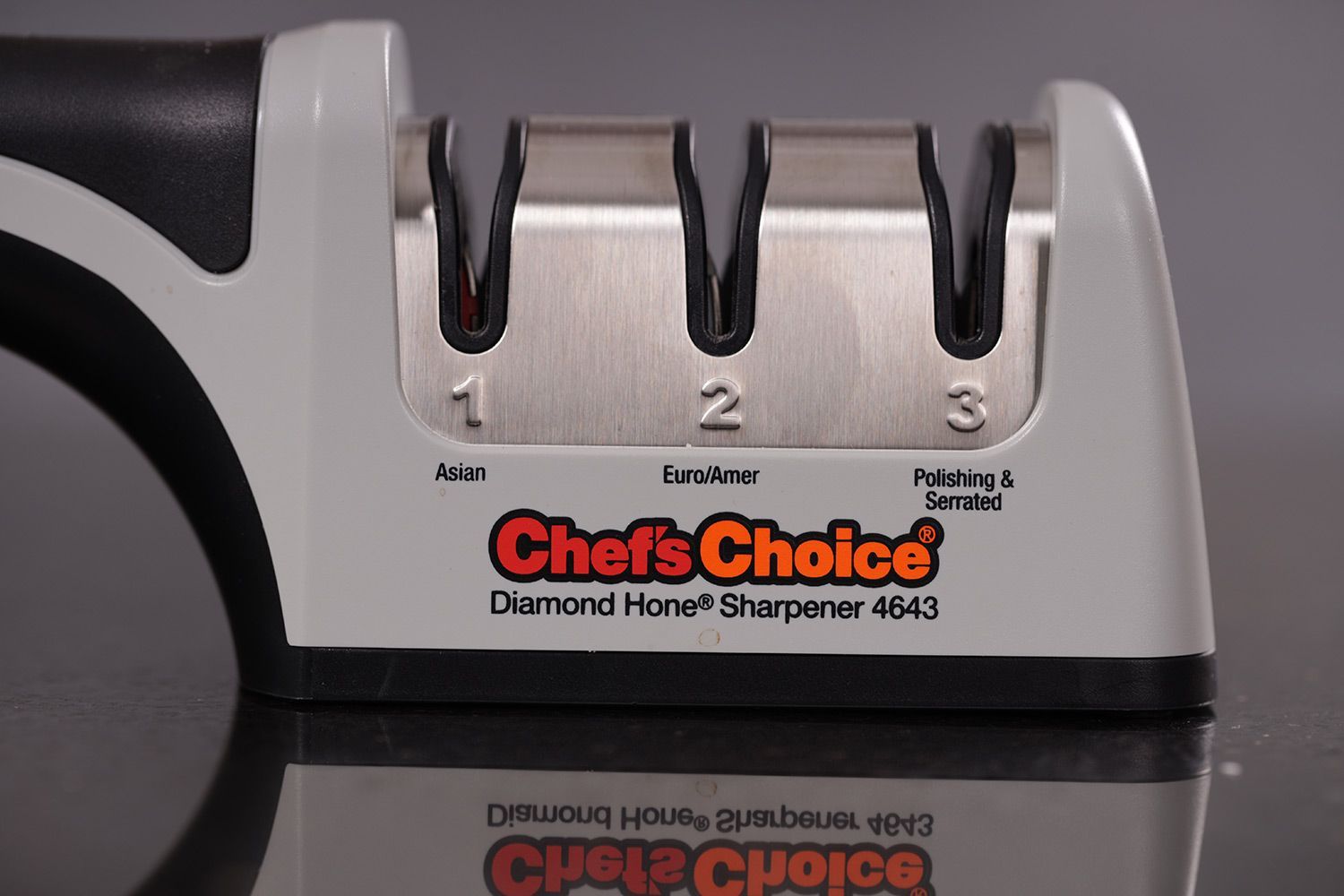 The working section of the Chef's Choice with 3 abrasive slots on a frame and part of its handle and base