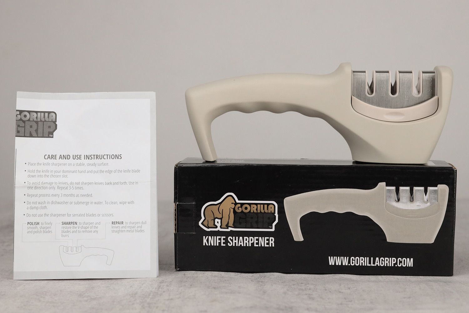 The Gorilla Grip sharpener on top of its package box with the instruction manual on the left side