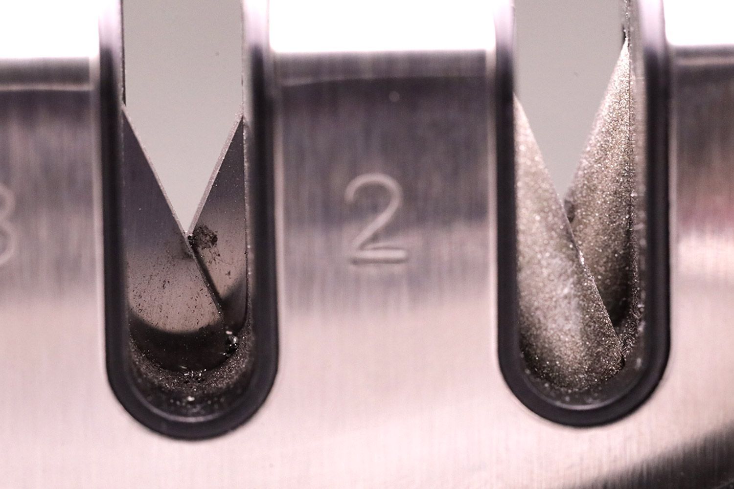 Medal residue on two abrasive slots on the Kitchellence knife sharpener