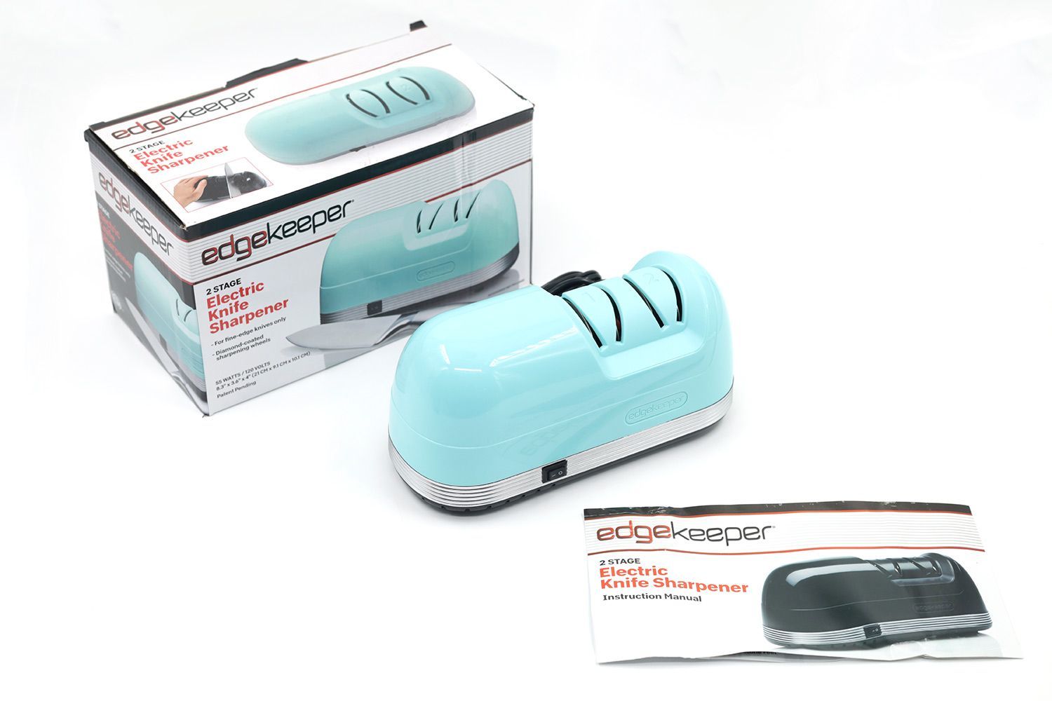 The EdgeKeeper electric knife sharpener next to its package box and instruction manual