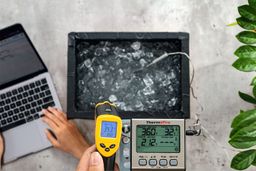 The Etekcity Lasergrip 1080 measures the surface temperature of an ice chest from 16 inches away. The screen reads 34.3°F.