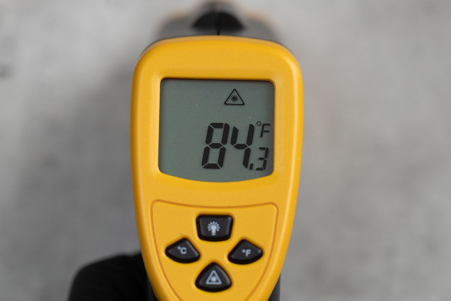 A close-up of the LCD screen panel of the Etekcity Lasergrip 800. The screen displays 84.3°F.