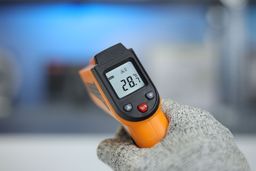 The LCD display panel of the Helect IR thermometer with the backlight turned on. The screen reads 28.7°C.