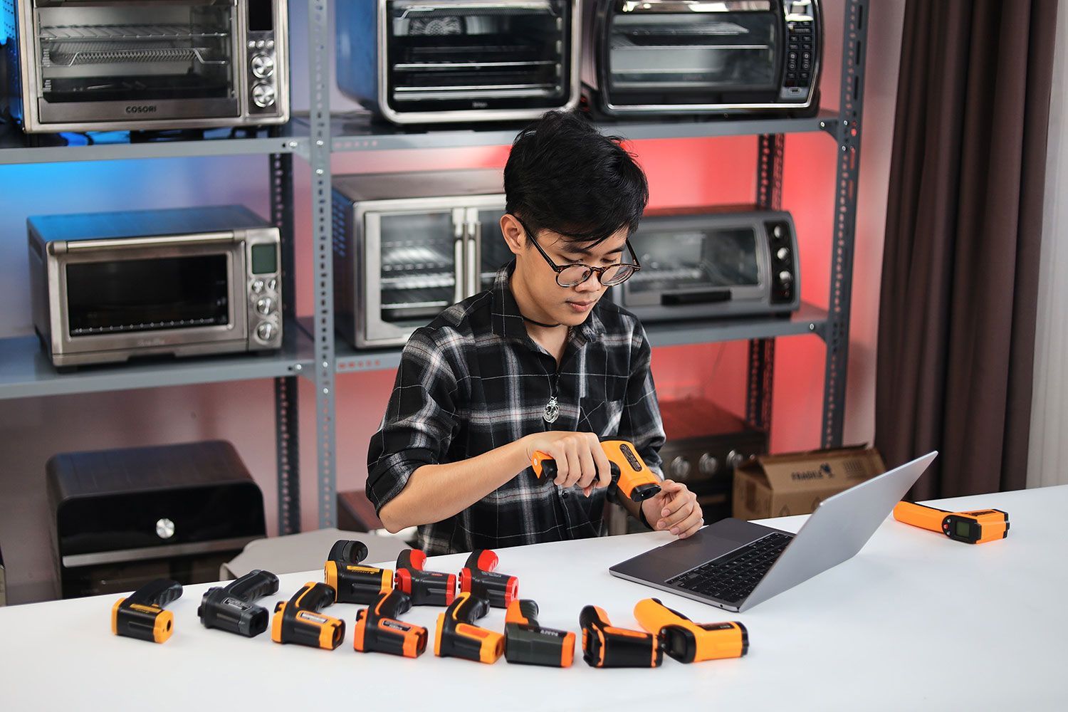 A reviewer (Matthew) inspecting one of the IR thermometers as part of our design assessment process.