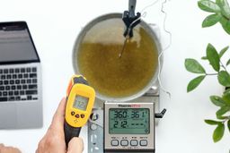 The Smart Sensor AS530 measures the temperature of an oil vat from 12 inches away. The screen reads 372°F.