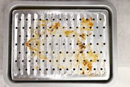 Grease on the broiling rack of the stainless steel BLACK+DECKER CTO6335S Convection Toaster Oven.